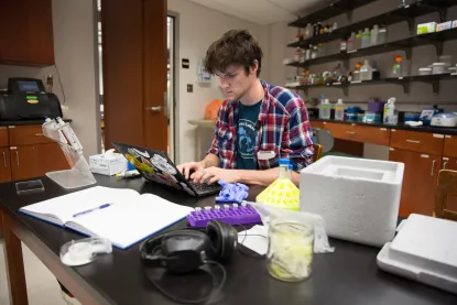 Male student doing work in a lab