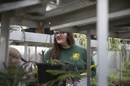 Student in NMU's greenhouse
