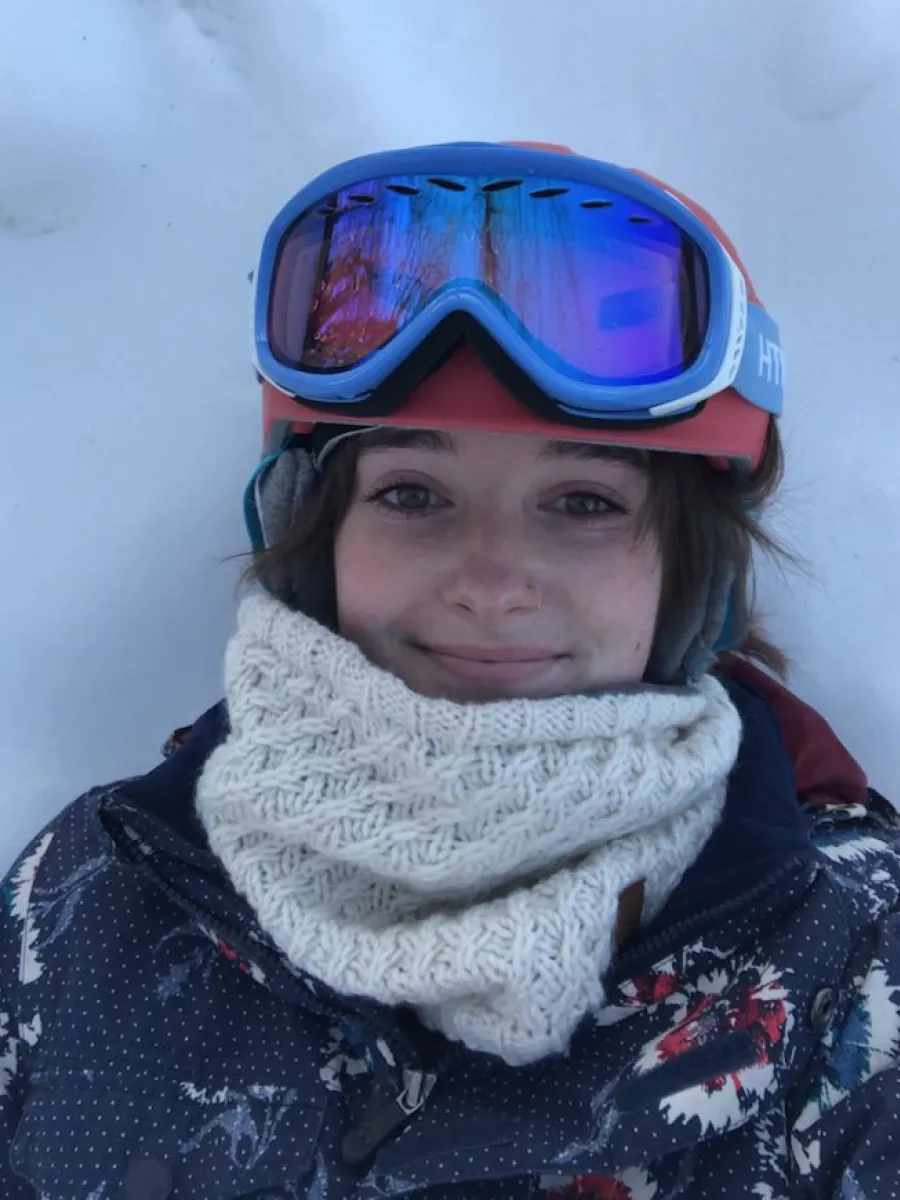 Hannah in the snow with a ski helmet on