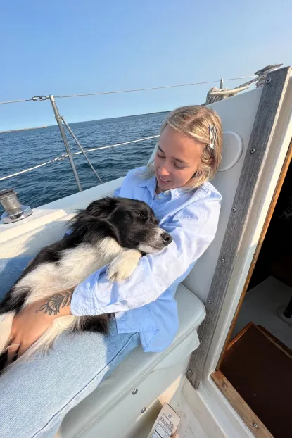 McKenna Sanford with a dog on a boat