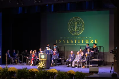 View of the Forest Robert's Theater stage with Dr. Tessam at the podium at his investiture ceremony