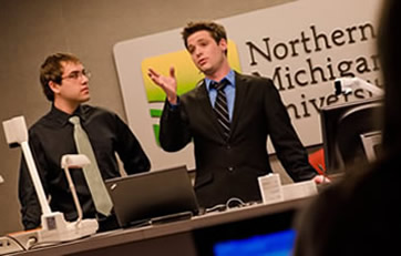 Clayton Powell (left), Dave Pfeiffer (right) and Steve Jarvis (not shown) earned third place in the recent Intel-NMU Computer Continuum App Programming Contest for their mobile phone app design, which they presented virtually to judges at Intel headquarters in Oregon.