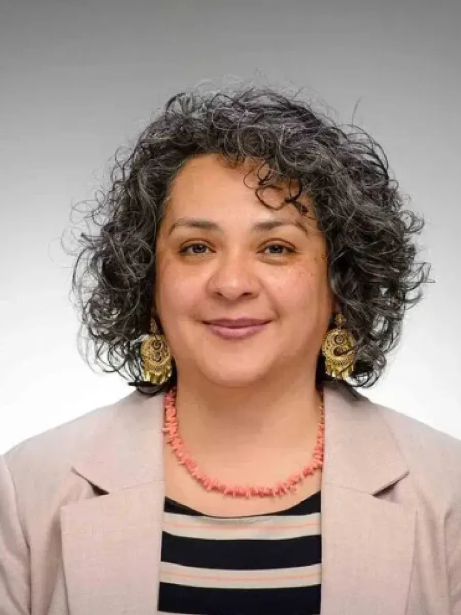 Dani Brenes portrait on light gray background.