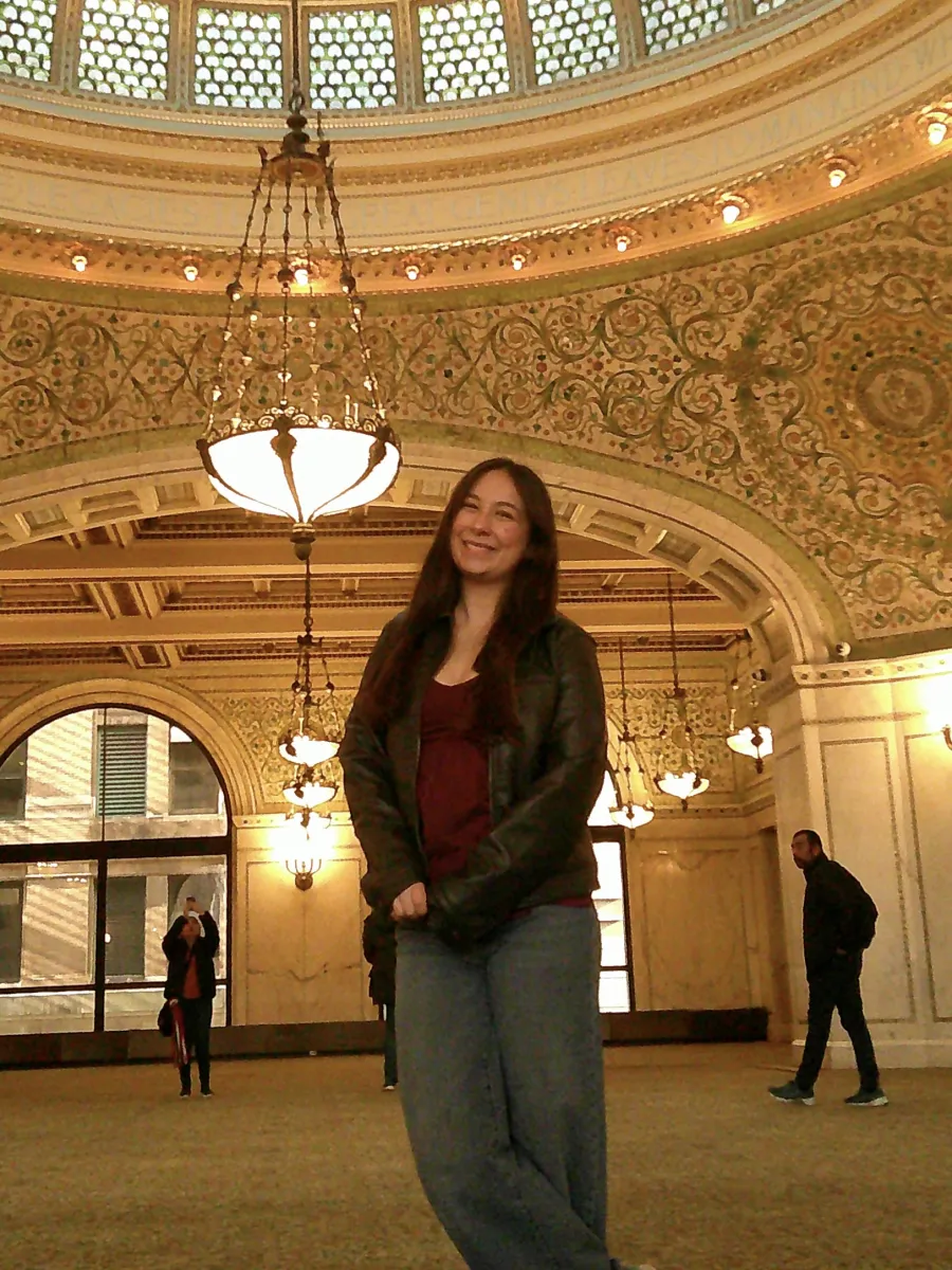 Kaia standing underneath an ornate, domed ceiling