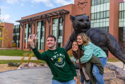 Student Brand Ambassadors with Wildcat Statue