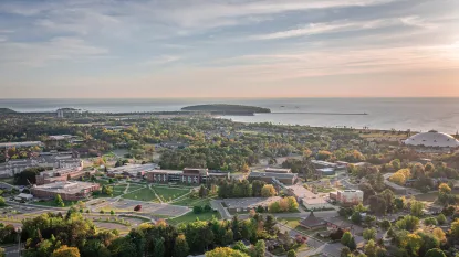 Aerial view of NMU Campus and Lake Superior at dawn
