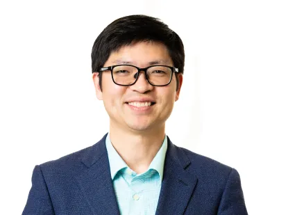 Portrait of Dr. You against a white backdrop