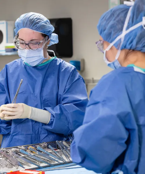 Two surgical tech students wearing full safety clothing in  the operating room lab at Nothern Michigan University
