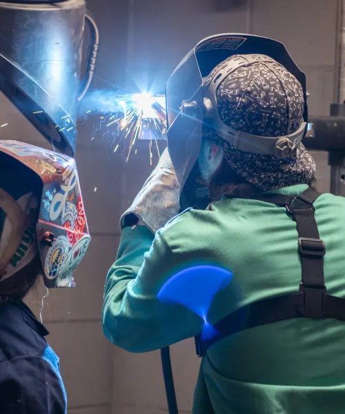Two NMU students welding
