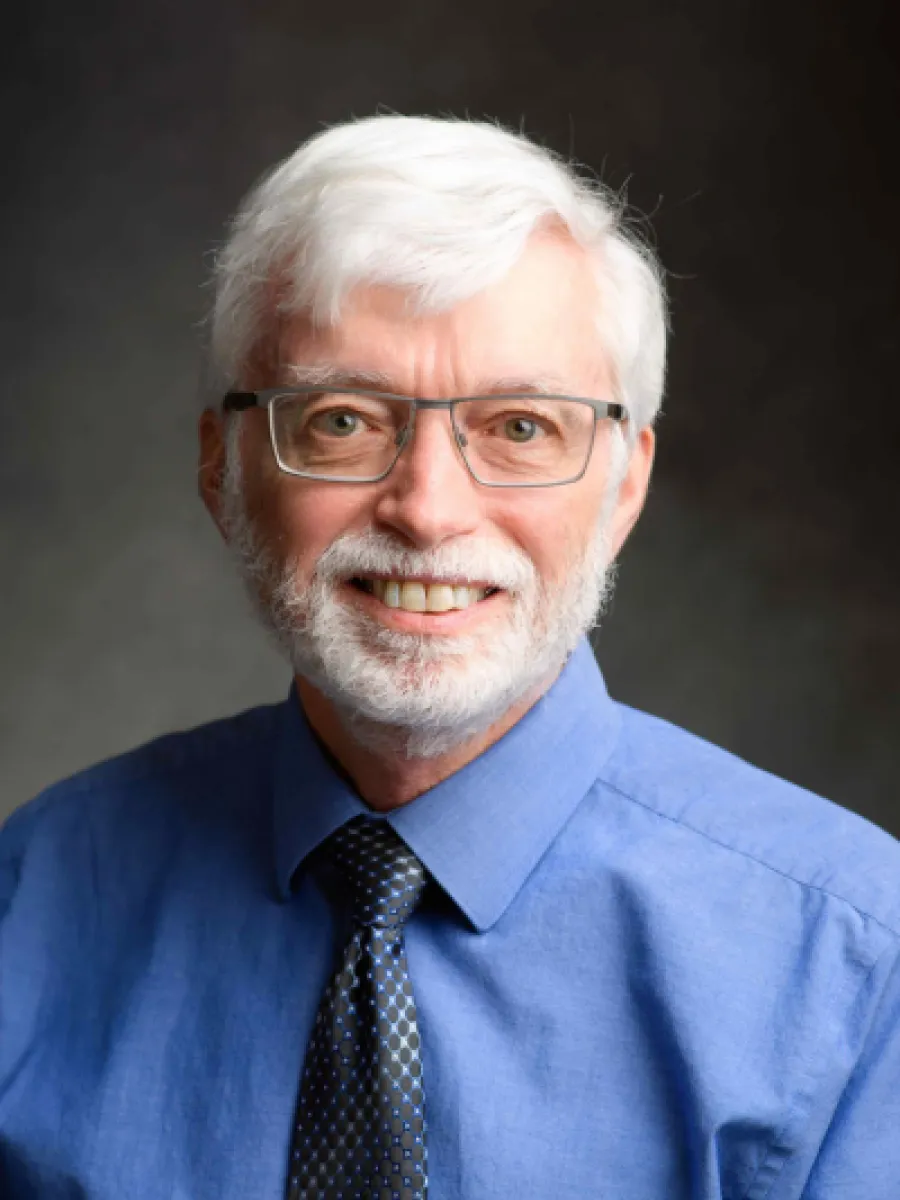 Headshot of Dr. Gary Bertoline in a white button up shirt and tie.