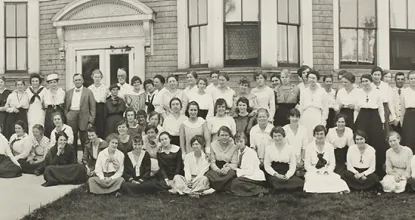 A group of people stand outside a dormitory at Northern in 1917.