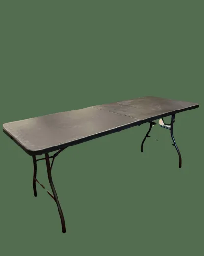 Large, black, foldable table stood up edited into a green background