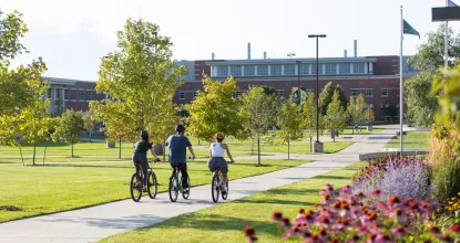 students biking in academic mall