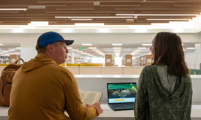 two students overlooking new library