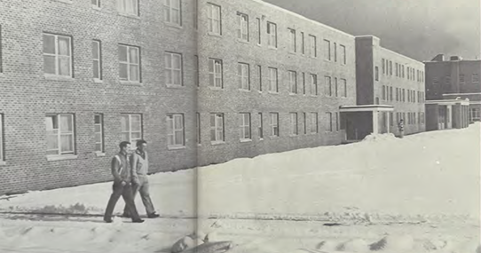 Two people walking in front of Spooner Hall