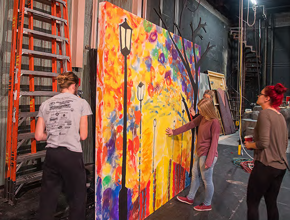 Students painting backdrop