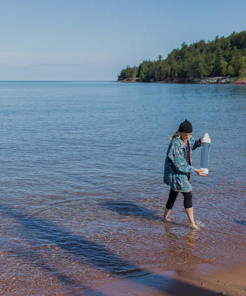 Female student conducting testing in Lake Superior