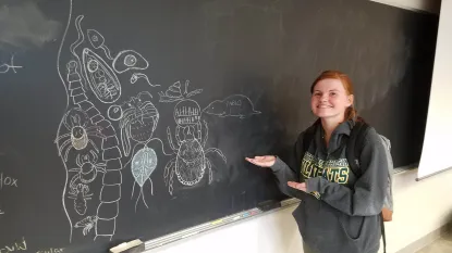 Nicolette Sexton with chalk parasite art 