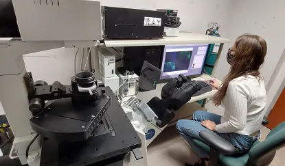 Student with confocal microscope