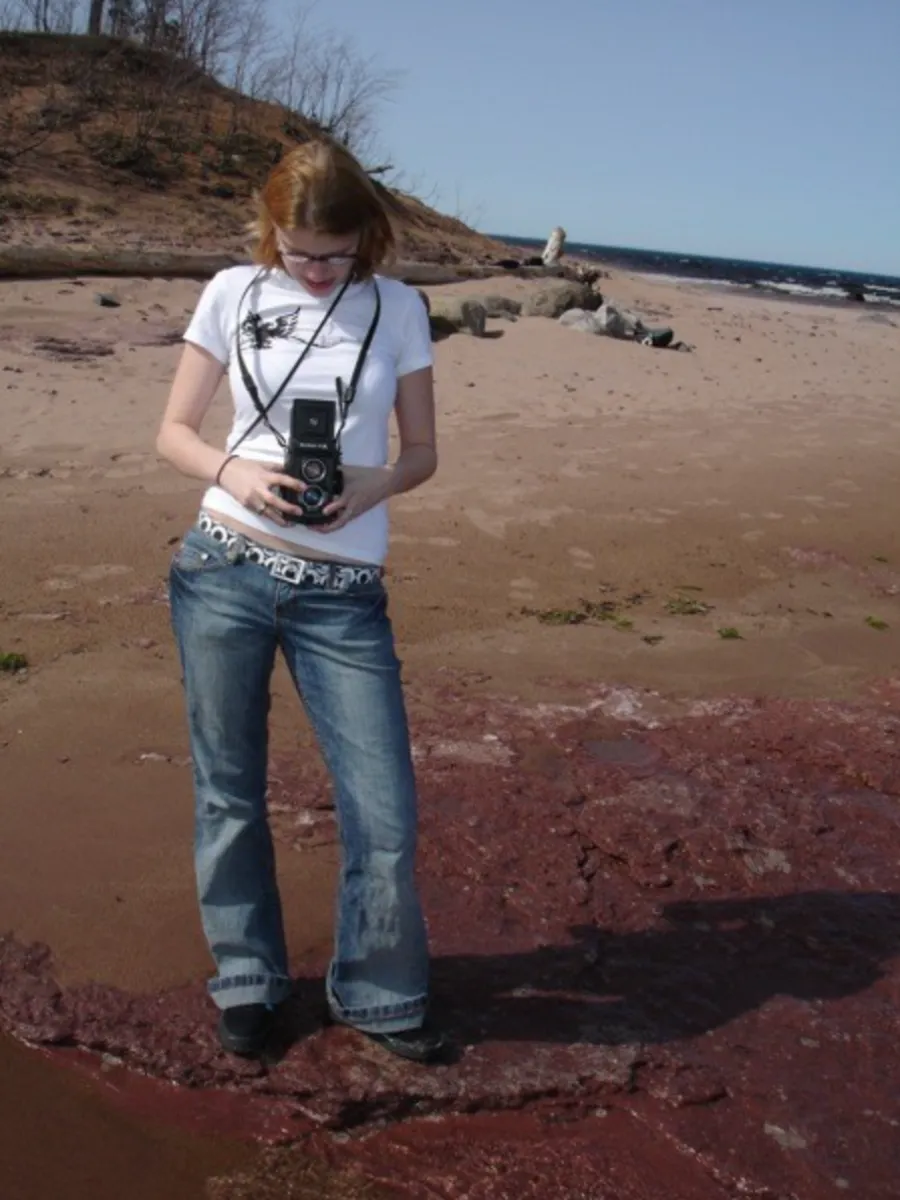 Cara with a camera on the beach