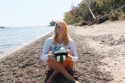 Mackenzie on the beach in her volleyball uniform