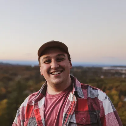 Man smiling on top of hill
