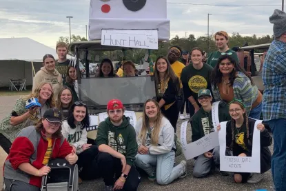 Students posing for a picture for the homecoming parade