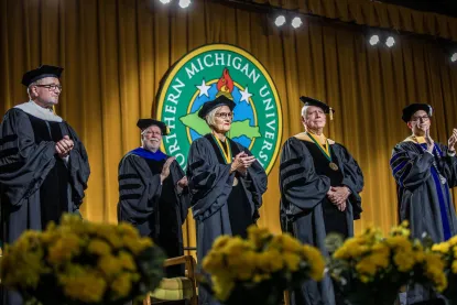 Board of Trustees on stage at the winter 2023 fall commencement ceremony