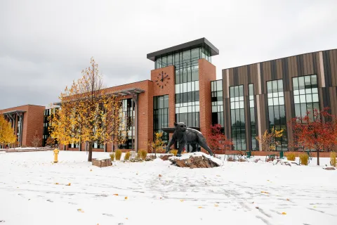 Exterior view of Jamrich Hall with the NMU Wildcat statue in front of the building.