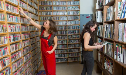 student picks cd off shelf