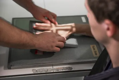 Student receiving a hand scan in the radiography lab