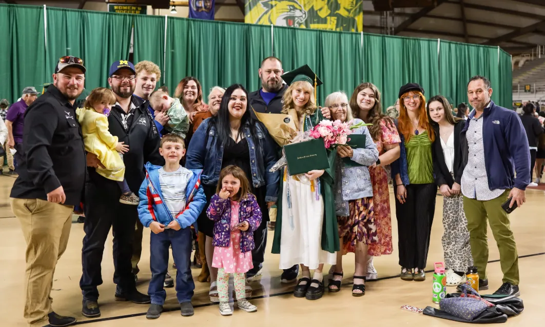 Family and Friends gathered around a graduate after Graduation
