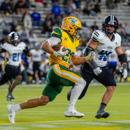 NMU football player running