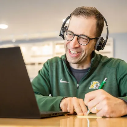 Man with headphone looking at laptop