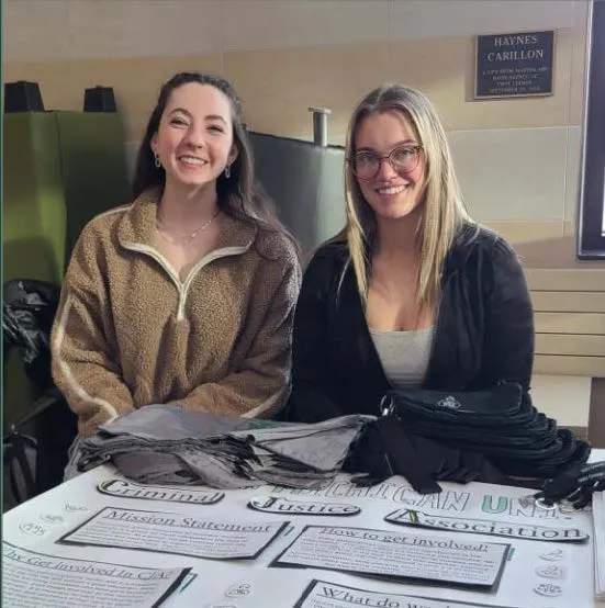 Students sitting at table during NMU Fall Fest