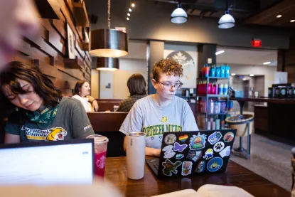 Students studying at a booth in the Jamrich Starbucks Location