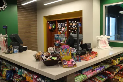 Cash registers at Cat Trax with candy boxes on the counter.