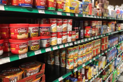 Shelves full of cans of soup and chili. 