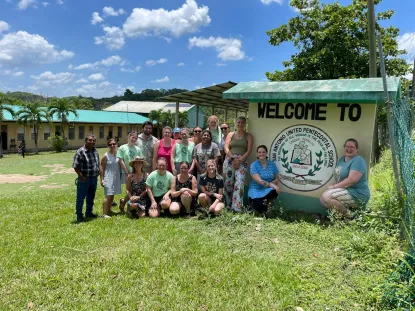 Studens in front of the Welcome to San Antonio United Pentecostal School in Belize