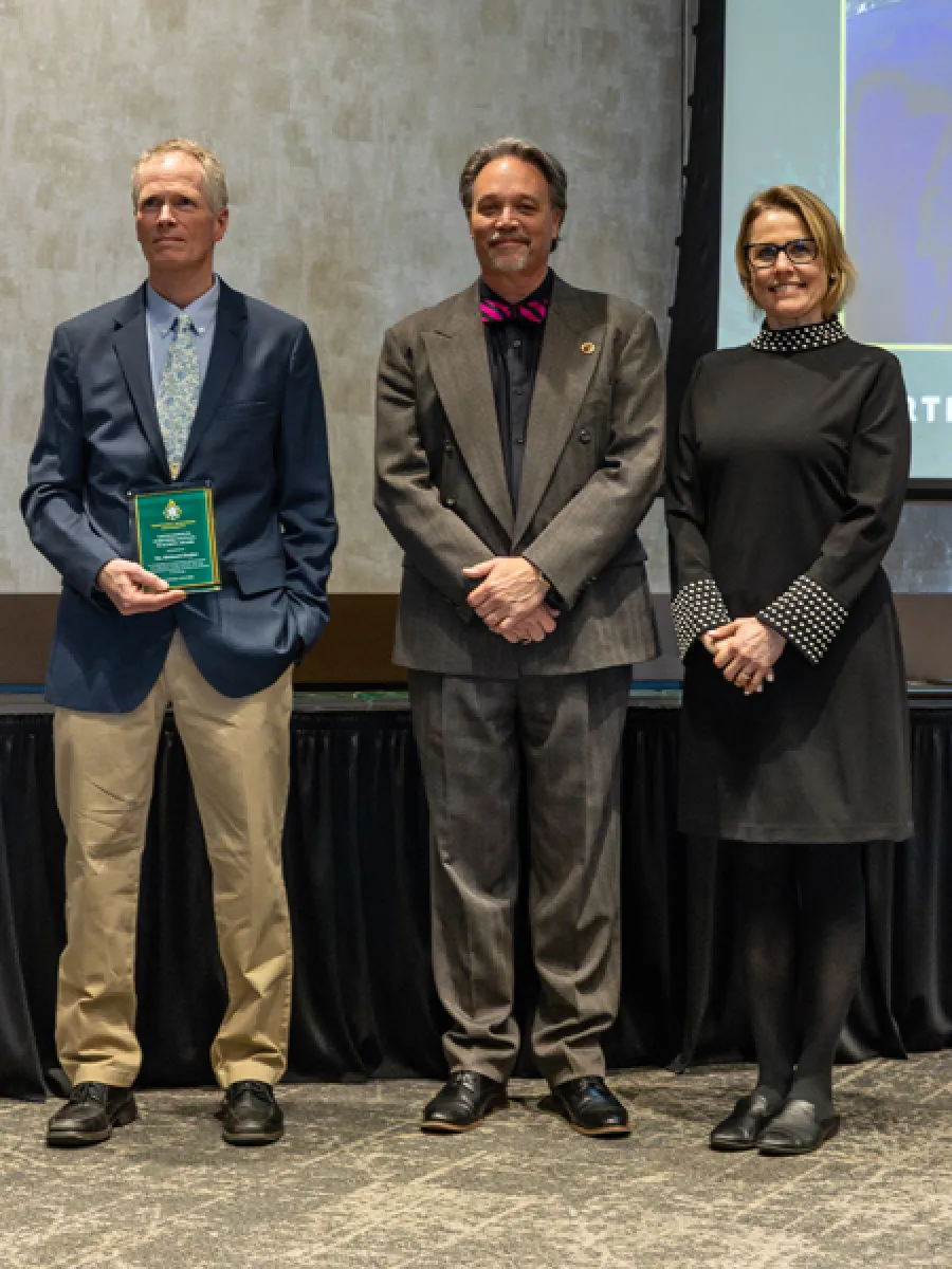 mr. richard ziegler receiving award, with president dr. chris olsen and provost dr. anne dahlman