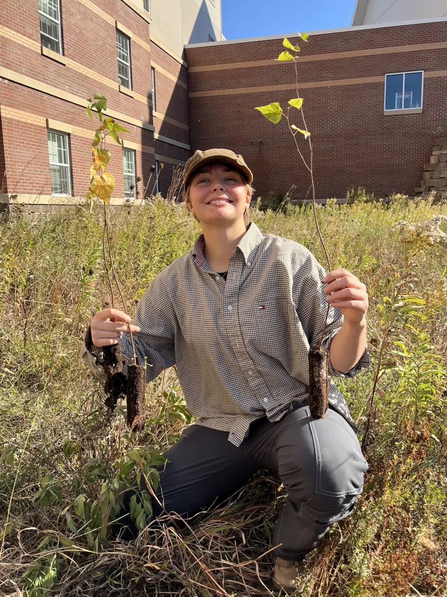 Brooklyn Moore planting Birch Trees outside the Woods in the OLA