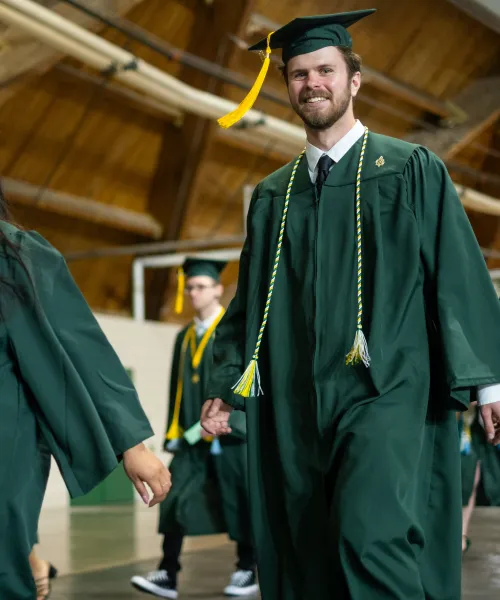 2025 Eng Tech Graduate walking into the dome for commencement