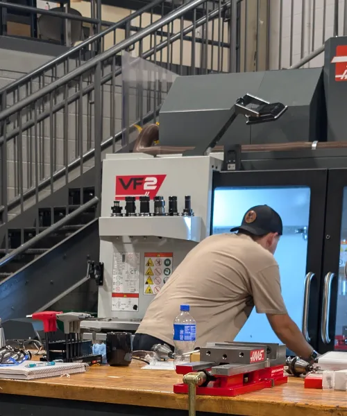 Students working on a project using a Haas VF-2 mill located in the manufacturing lab in the NMU Jacobetti Complex.