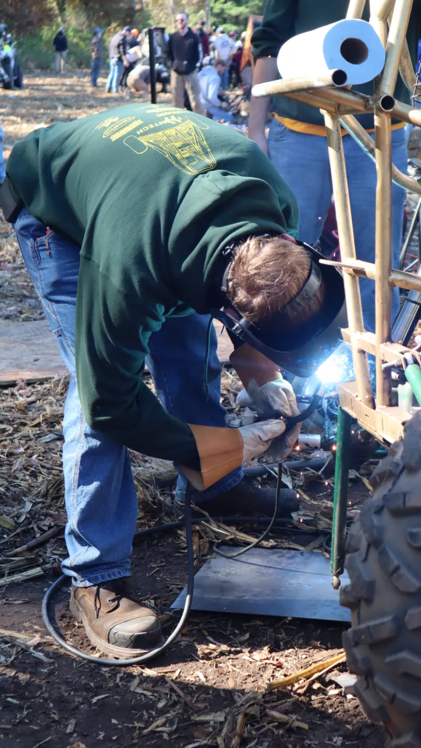 Team member welding a joint on the back of the racing vehicle.