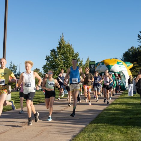 Participants crossing starting line as they begin the 5K run and walk.