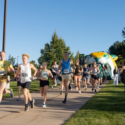Participants crossing starting line as they begin the 5K run and walk.