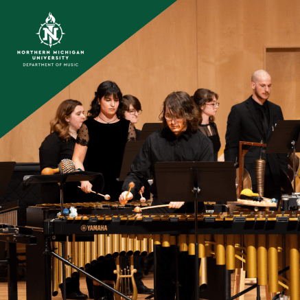 Northern Michigan University percussion students perform focused and engaged on mellophones, xylophones, gongs, and other instruments.