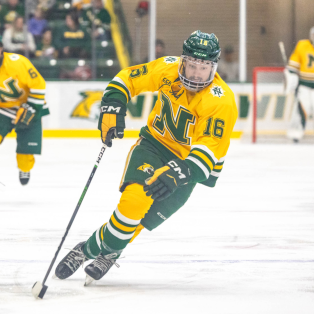 male hockey player wear a yellow Northern Michigan University jersey