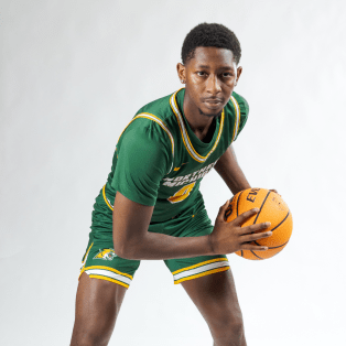 male basketball player holding a basketball