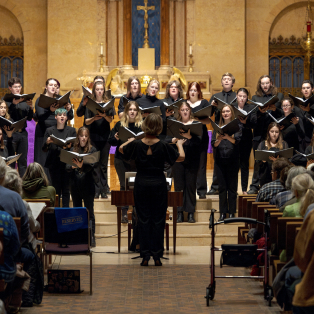 Dr. Erin Colwitz directing one of the NMU Choral Ensembles in a performance at St Peter Cathedral